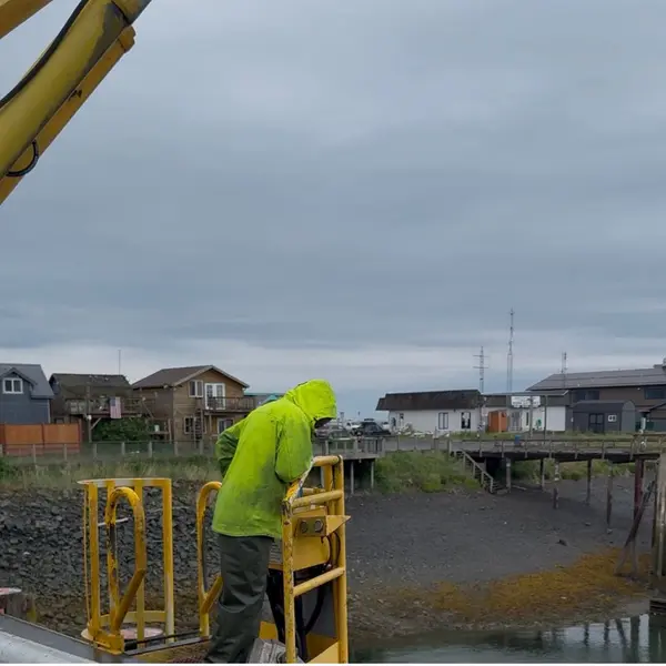 The crane operator brings up bags of halibut