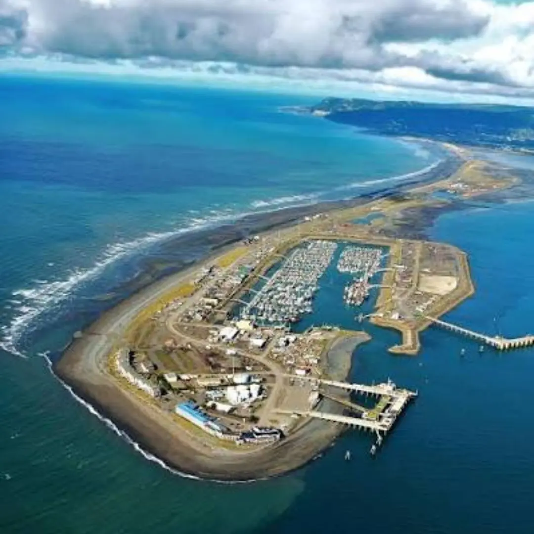 Aerial view of the Homer Spit's small-boat harbor packed with fishing vessels, Kachemak Bay all around